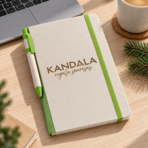 Libreta A5 de cartón reciclado personalizada con bolígrafo con el logotipo de Kandala en contexto de regalo de empresa